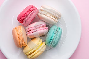 Colorful pastel cake macaron or macaroon on plate.
