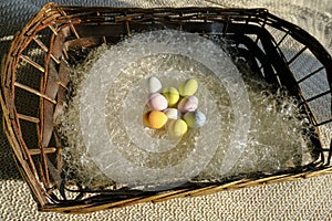 Colorful pastel Easter eggs in basket close-up. Top view. easter holidays card