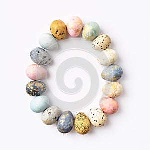 Colorful pastel Easter eggs in egg shape on white background.