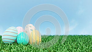 Colorful pastel Easter eggs on green grass floor and clear blue sky background