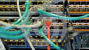 Colorful patch cords connected to a working switch panel.