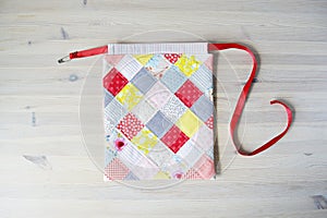 Colorful patchwork drawstring bag and safety pin