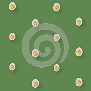 Colorful pattern of chicken eggs on green background. Top view. Flat lay. Pop art design