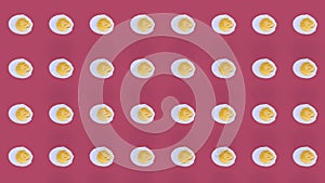 Colorful pattern of chicken eggs on pink background. Seamless pattern with egg. Top view. Realistic animation. 4K video