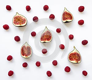 Colorful pattern of fig fruits and raspberries. Flat lay, top view