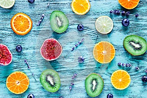 Colorful pattern made of fruits on green wood