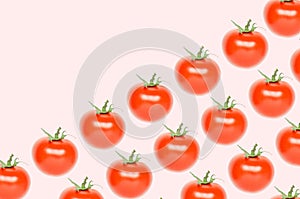 Colorful pattern of red tomatoes on pink background.