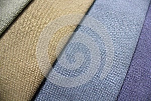 Colorful patterns of upholstery fabric. Close-up of samples of furniture fabric. Multicolored soft textile. Furniture industry.