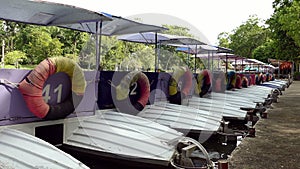 Colorful pedal boats parked in a long line