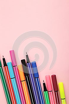 Colorful pen on pink background. Space for text