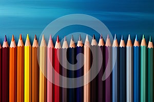 Colorful pencil arrangement on textured canvas, text space to accentuate