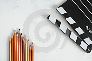 Colorful pencil and black movie clapper board