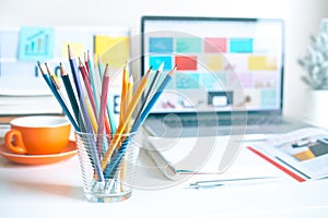 Colorful pencil in glass on desk table in home office.business creativity