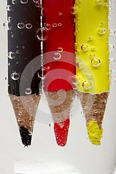 Colorful pencil under bubbled water