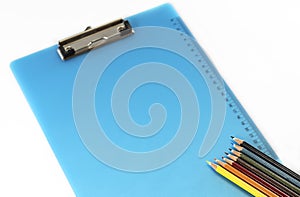 Colorful pencils and clipboard