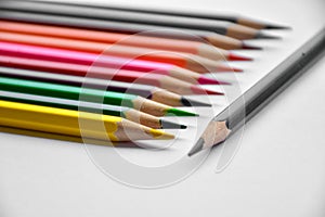Colorful pencils in glass on white background