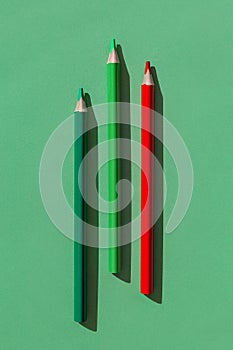 Colorful  pencils on green background. Minimal style composition. Top view. Flat lay. Back to school concept