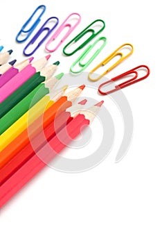 Colorful pencils and paperclips, office stationery