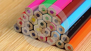 Colorful pencils rotate as a background. Rainbow pencils for drawing. Assortment of colored pencils. Back to school