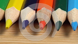 Colorful pencils rotate as a background. Rainbow pencils for drawing. Assortment of colored pencils. Back to school