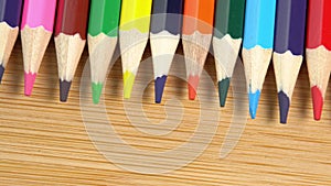 Colorful pencils rotate as a background. Rainbow pencils for drawing. Assortment of colored pencils. Back to school