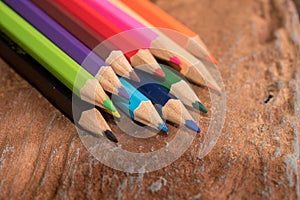 Colorful pencils on wood table