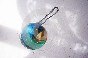 Colorful pendant painted in watercolor on a white background