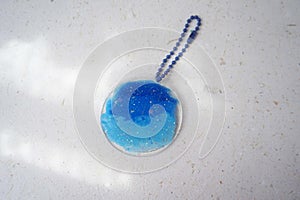 Colorful pendant painted in watercolor on a white background