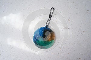 Colorful pendant painted in watercolor on a white background