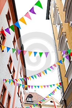 Colorful pennants hanging on house facades for street festival