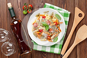 Colorful penne pasta and white wine