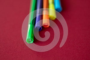 Colorful pens on red background