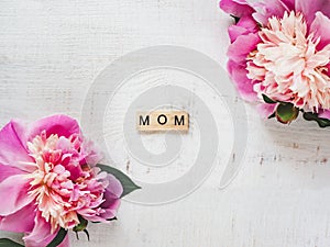 Colorful peonies and word MOM on a white background