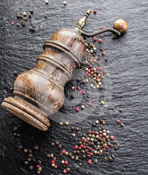 Colorful peppercorns and old pepper mill