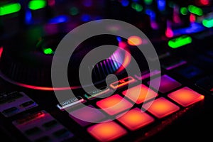 Colorful Performance MPC Pads on DJ Controller with blurred jog wheel