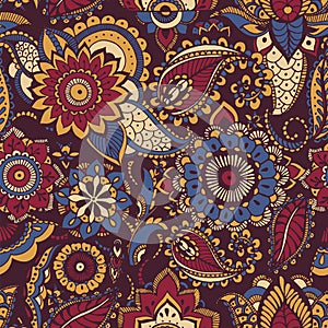 Colorful Persian paisley seamless pattern with buta motif and oriental floral mehndi elements on dark background. Motley