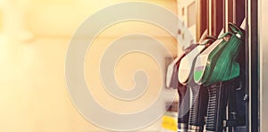 Colorful petrol and diesel nozzles of dispenser machine at the gas fuel station