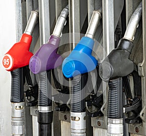Colorful Petrol pump filling nozzles, Gas station in a service in daytime