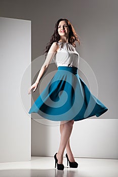 Colorful photo of a woman in white top and dark blue skirt
