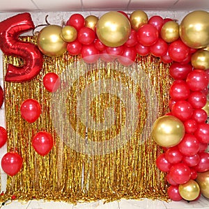 Colorful photo zone for the 5th anniversary of a child in golden color with