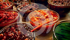 Colorful Pickled Fruits in Vinegar for Sale in a Traditional Iranian Bazaar