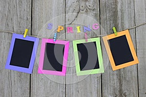 Colorful picture frames hanging on clothesline