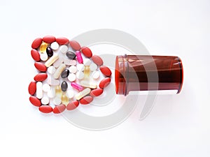 Colorful of pills, analgesics, painkillers and capsules with heart-shaped medicines, concept Love and health care when illness.