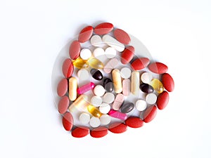 Colorful of pills, analgesics, painkillers and capsules with heart-shaped medicines, concept Love and health care when illness.