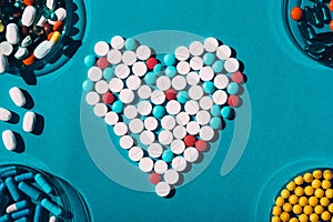 Colorful pills in heart symbol