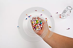 Colorful pills and medicines are placed on the hand.