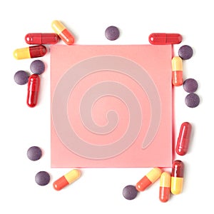 Colorful pills and paper for notes