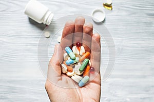 Colorful pills and tablets in the hand