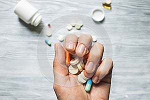 Colorful pills and tablets in the hand