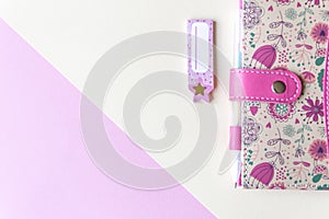 Colorful pink background with party decoration, notebook and free space for text, mock-up. Top view. Learning to draw, making wish